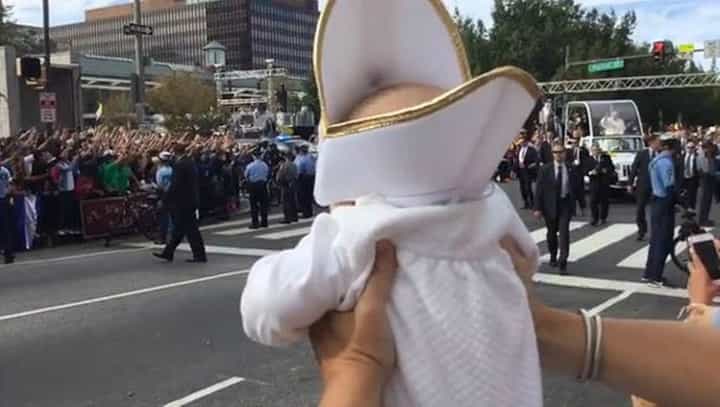 WATCH: Pope Francis cracks up when he sees a baby dressed just like him