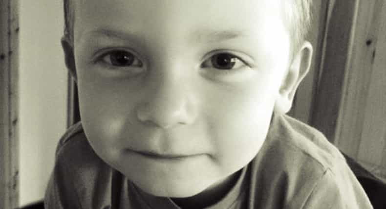 This is Aaron. His mum has chained herself to the Dept. gates in a row over his education.