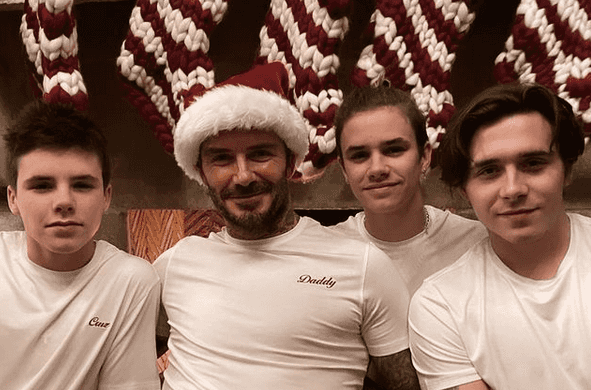 Victoria Beckham is every mum trying to get the kids to pose for a Christmas card photo