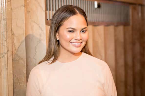 Chrissy Teigen shows off baby bump for the first time and she is glowing