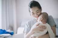 A mother holding her new born baby