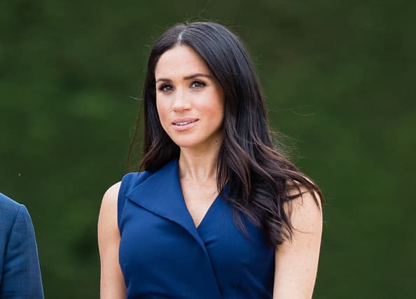 Texting on the job? Meghan was caught with her phone out on the royal tour