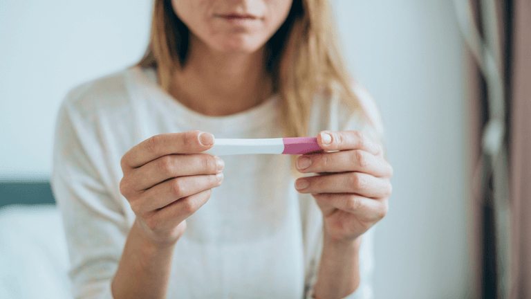 What is an ectopic pregnancy and what are the symptoms?