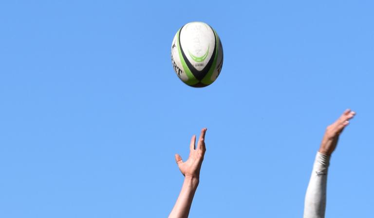 Working mum: Rugby player applauded for breastfeeding her daughter at side of pitch