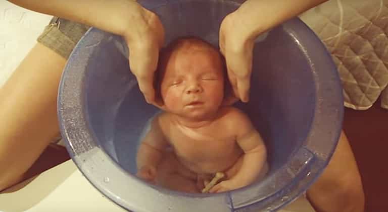 Newborn Baby Enjoys First Bath in the Tummy Tub Newborn Baby Enjoys First Bath in the Tummy Tub
