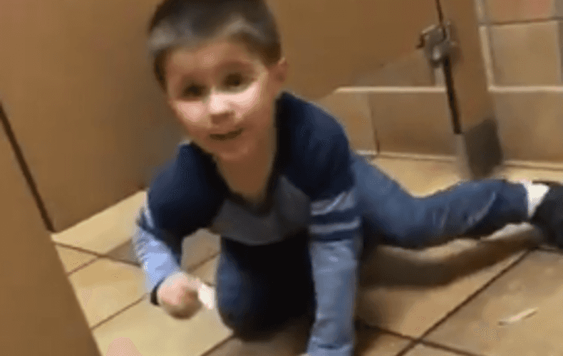 A little boy innocently climbed under a man’s bathroom stall while he was using the toilet