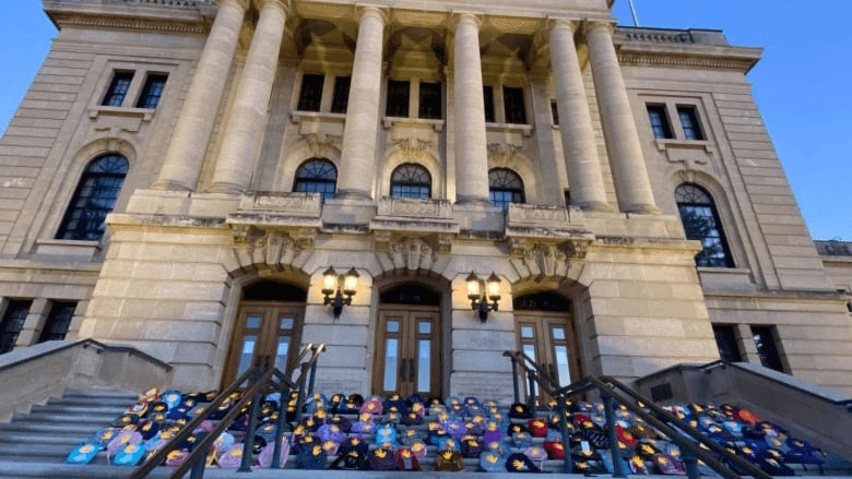 Hundreds of backpacks left as memorial to children found in mass grave at residential school