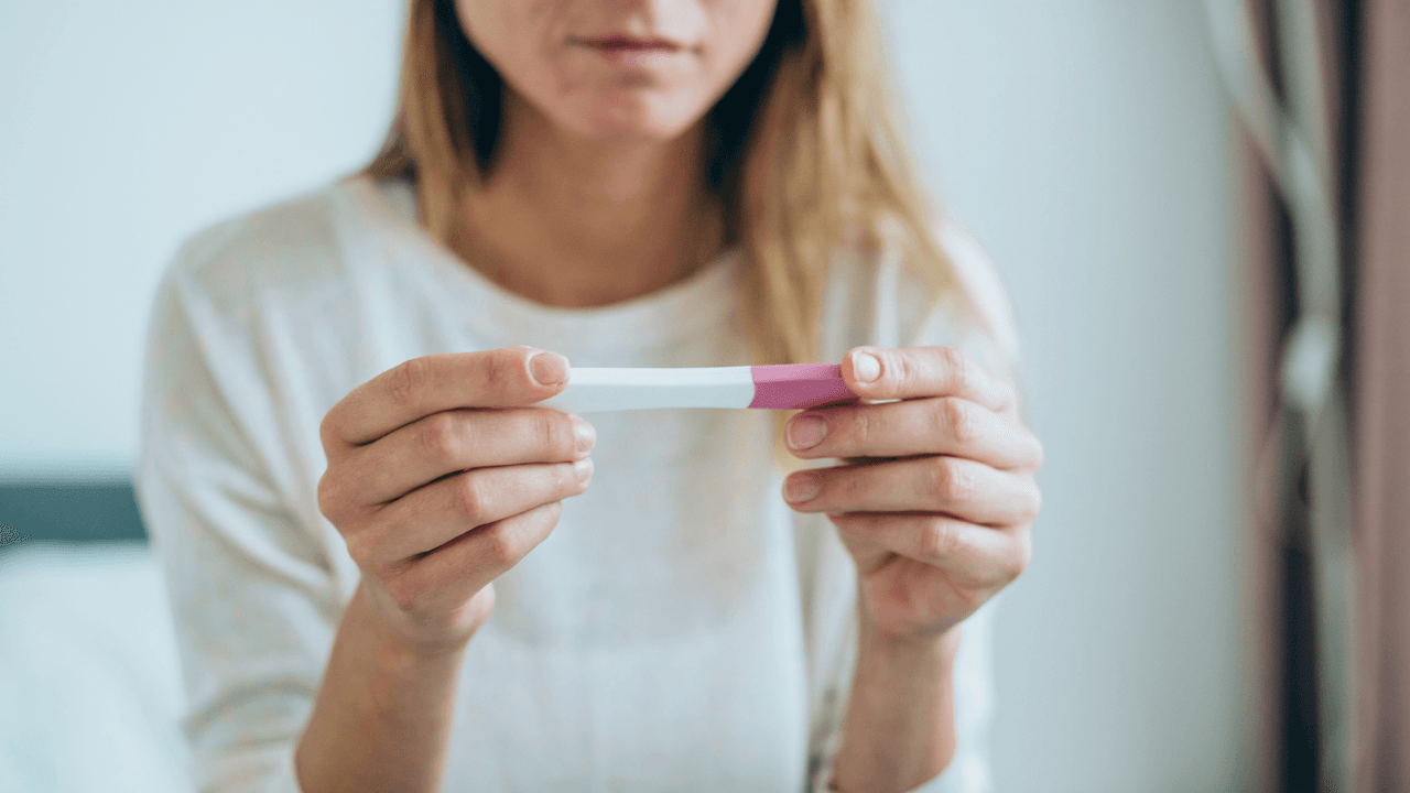 What is an ectopic pregnancy and what are the symptoms?