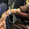 Adorable toddler fist bumping his way onto a flight will make your day