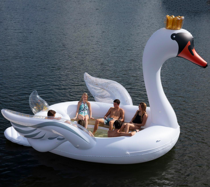 You can now get a giant glitter swan pool float that fits the whole family