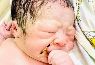 Baby pictured holding mum’s failed IUD after ‘miracle’ pregnancy