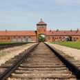 Woman called out after posing for photos on Auschwitz train tracks