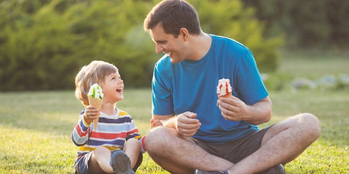 Father and son eating ice cream in the park
