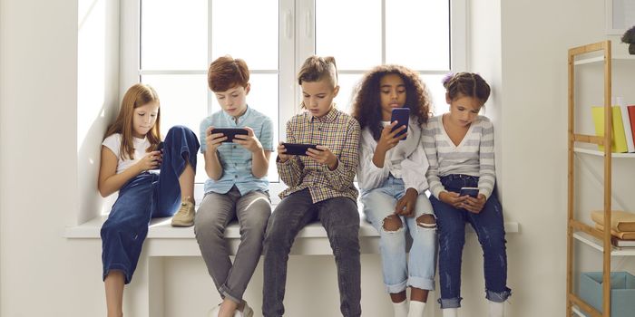 Five kids all on smartphones